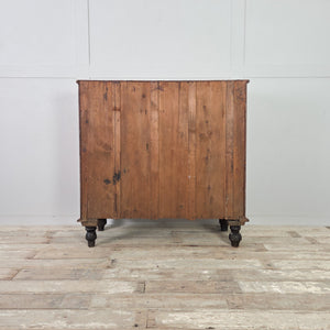 Antique pine chest of drawers with original buttermilk painted finish, raised on four dark contrasting bun feet