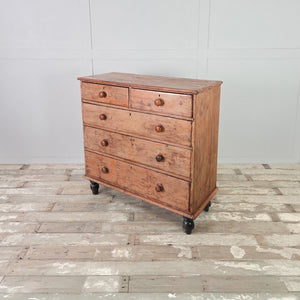 Antique pine chest of drawers with five graduating drawers, original paintwork, and four dark contrasting bun feet
