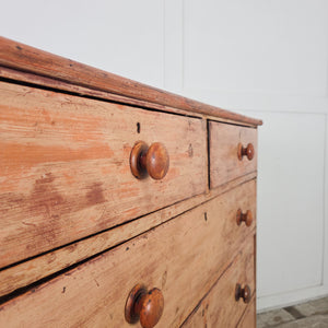 Victorian pine chest of drawers with five graduating drawers, turned wooden knobs, and original painted finish
