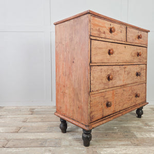 Antique painted pine chest of drawers with five graduating drawers and matching turned wooden knobs throughout

