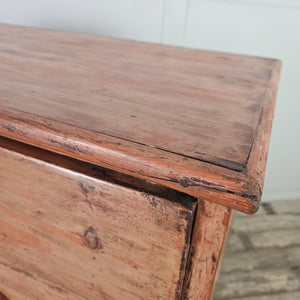 Victorian pine chest of drawers with original buttermilk painted finish and four dark contrasting bun feet below
