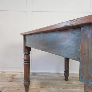 Antique pine table with a single apron drawer, cast iron handle and four turned shaped legs