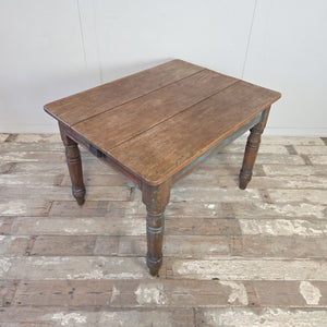 19th century pine kitchen table with four turned and shaped legs and a distressed painted base
