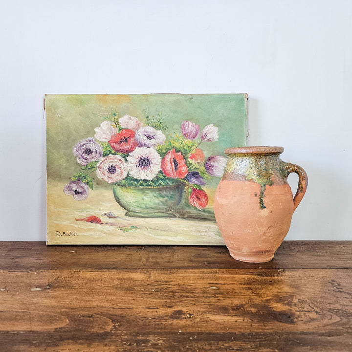 Classic De Becker oil painting of colorful flowers next to a rustic terracotta jug on a wooden surface, showcasing the artwork's texture and rich colors