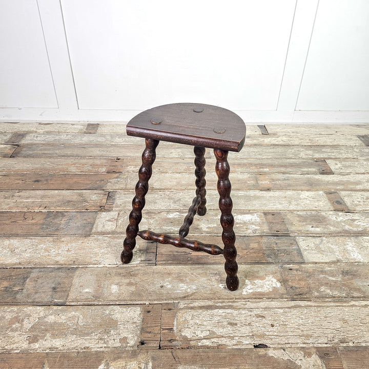 French vintage oak stool with bobbin legs.
