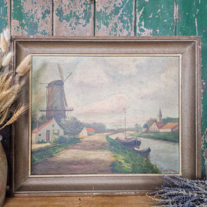 Belgian countryside artwork capturing a windmill set against a cloudy sky.
