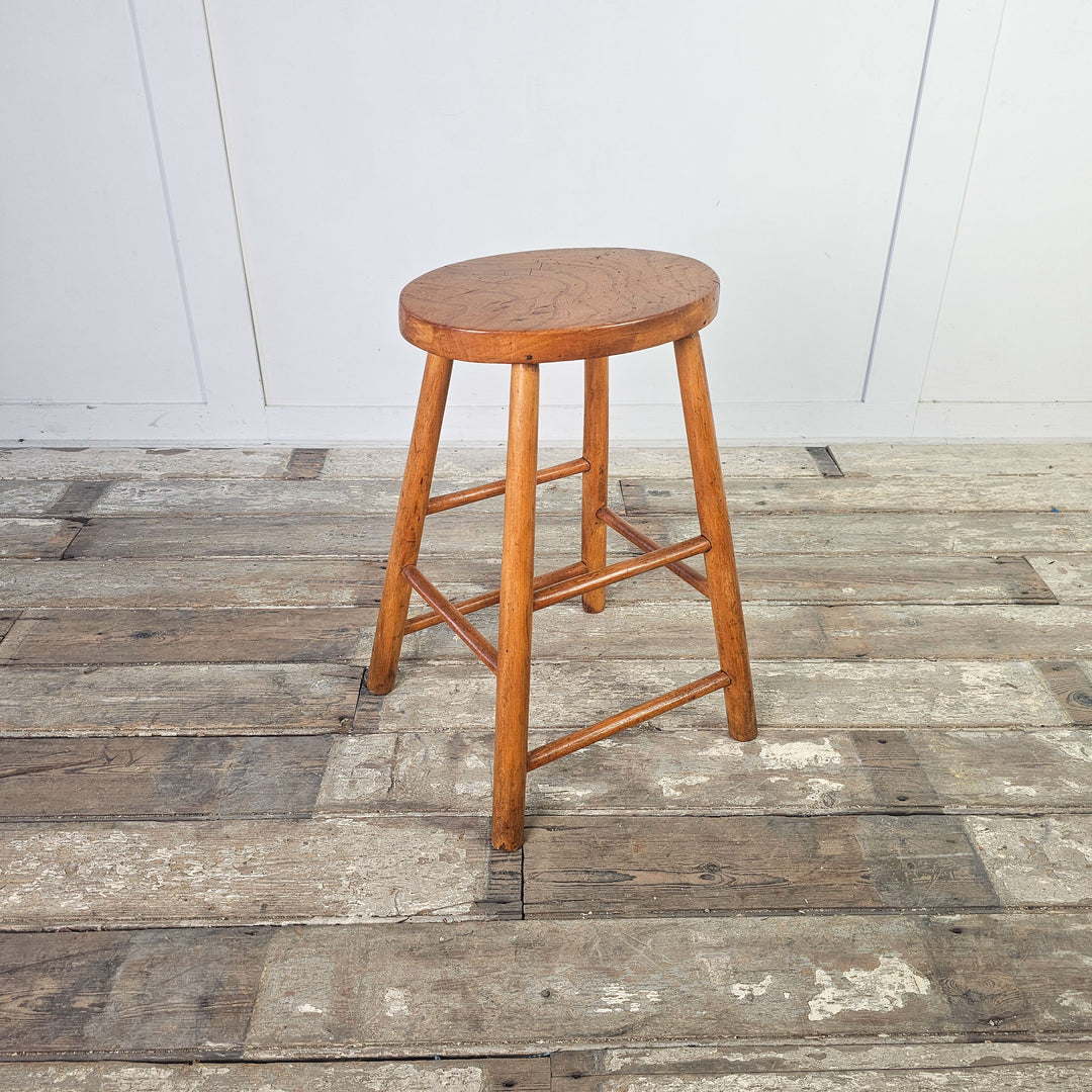 Vintage mid-century elm stool with oval seat and straight legs.
