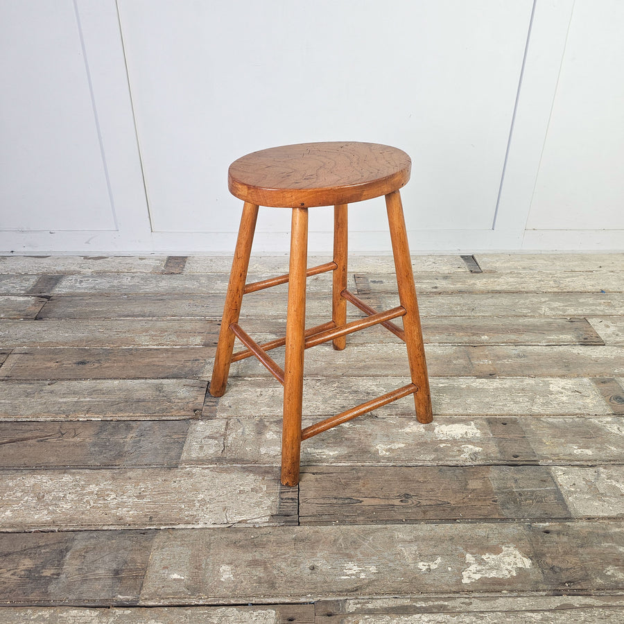Vintage mid-century elm stool with oval seat and straight legs.
