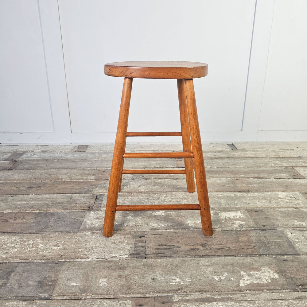 Timeless elm stool with patina finish and oval seat from the mid-century.
