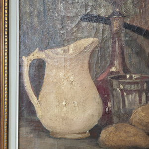 Belgian oil on canvas still life painting from the 1940s, set within a carved wooden frame. The subject matter includes a jug, glass, decanter, and copper pan, painted in soft, earthy tones. An original work by Bertha Lombet, suitable for various home settings.
