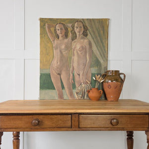 An original vintage nude portrait in oil on canvas, depicting two female figures against a minimal backdrop of greens and browns, ideal as a mid-century focal point in the home.
