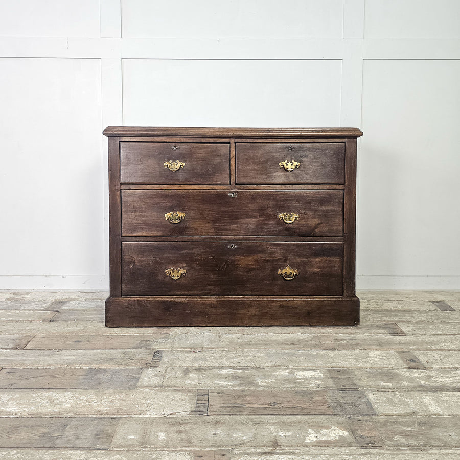 Dark-stained pine chest with spacious drawer layout.
