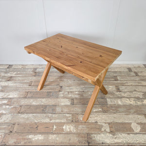 Vintage farmhouse pine trestle table with X-frame base and stripped pine finish. The table is sealed with wax for protection and features a thick top with visible grain. Its simple yet robust form makes it suitable as a dining table, desk, or console, blending seamlessly into rustic and modern interiors.