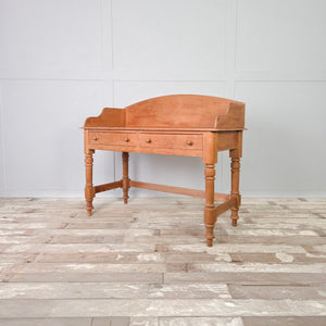 This vintage pine console table has two drawers and a shaped gallery back, raised on four turned legs. A beautiful country-style piece suitable for use as a hall table in a hallway or living room, with drawer storage for smaller household items.