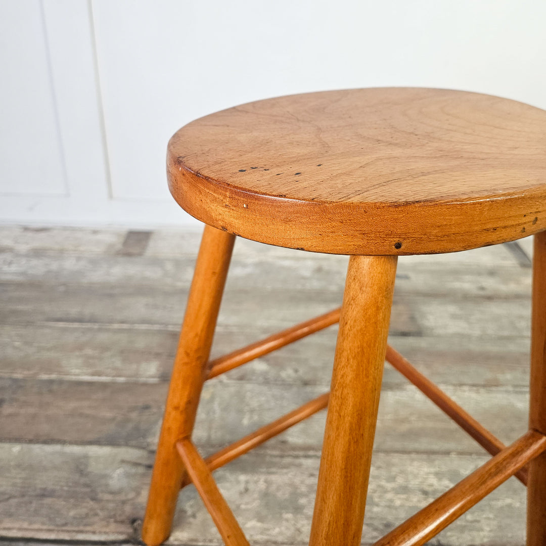 Versatile elm stool with oval seat, suitable for any room.
