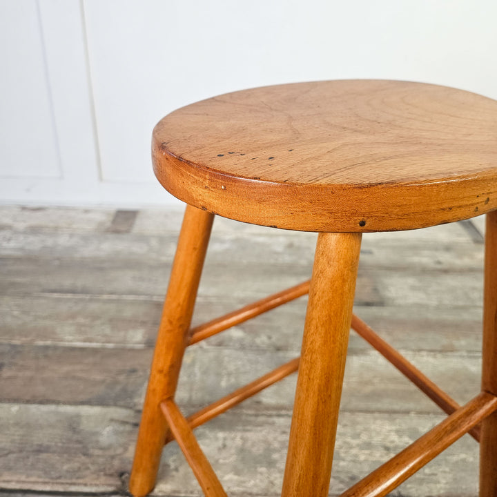 Versatile elm stool with oval seat, suitable for any room.
