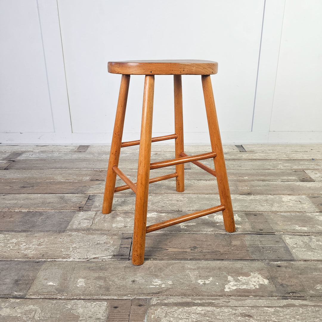 Elm wood mid-century stool, perfect for adding a rustic touch.
