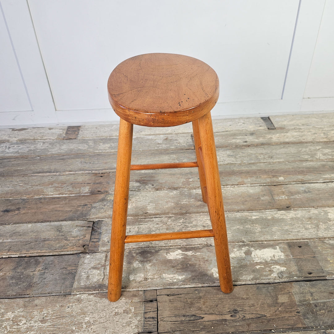 Elm stool from the mid-century, featuring a classic oval seat.
