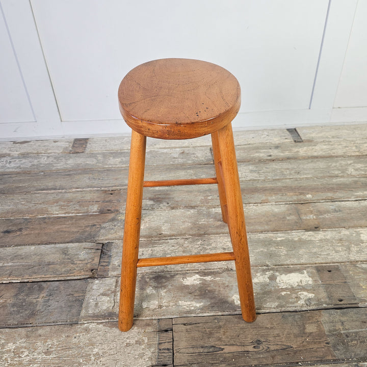 Elm stool from the mid-century, featuring a classic oval seat.
