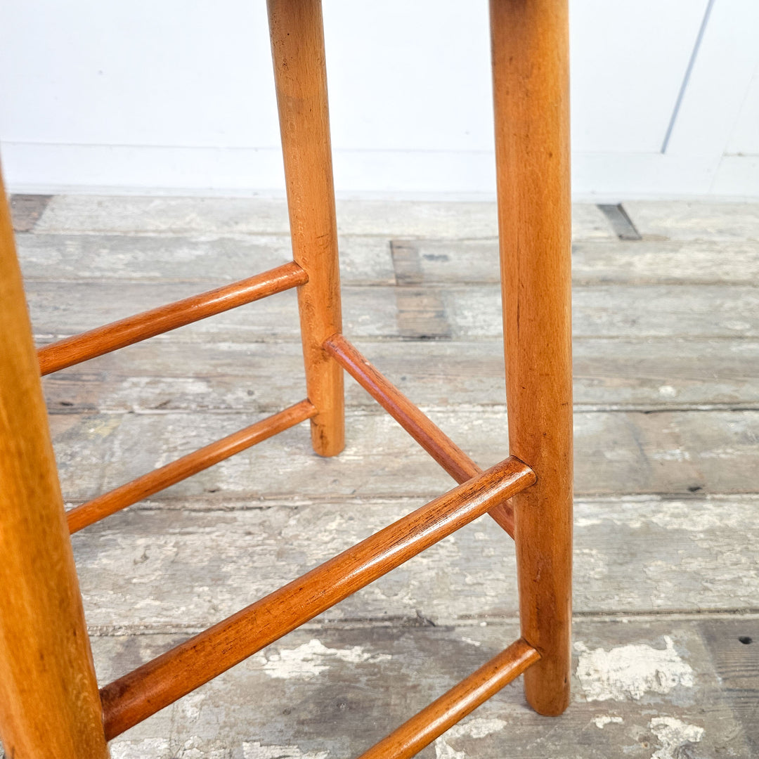 Mid-century art studio elm stool, oval seat, with leg stretchers.
