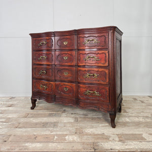Antique 19th century French walnut chest of drawers with four full-width drawers, serpentine form to the front, and original brass plate drop handles.

