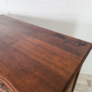 Louis XV style French serpentine commode in walnut, dating from the 19th century, showing graduating drawer depths and decorative brass fittings.
