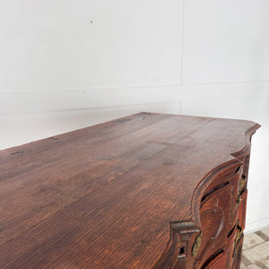 19th century French walnut chest of drawers or commode with a serpentine front, graduating drawer depths, and decorative brass escutcheons.
