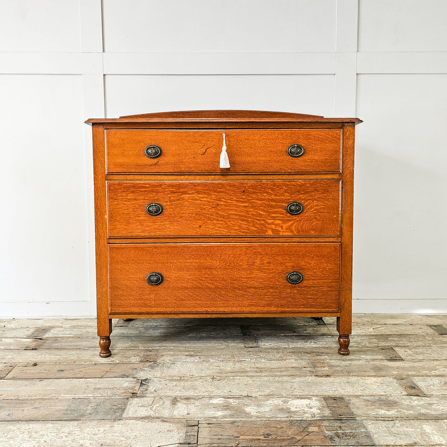 Antique oak chest of drawers by Waring and Gillow, early 20th century