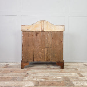 A rustic pine Victorian chest of drawers with a gallery top and four drawers arranged in a two-over-two layout. Wooden knobs and bracket feet complete this farmhouse style storage chest suitable for household organisation.