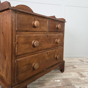 A rustic pine Victorian four-drawer chest with a gallery top and bracket feet, offering a sturdy country house style storage option. The two-over-two arrangement and wooden knobs create simple, cottage style bedroom drawers.