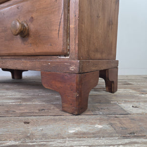 A dark-stained Victorian pine chest of drawers with a rustic, country house character. Featuring two short and two long drawers, a gallery top and bracket feet, it works as a farmhouse style sideboard or cottage style bedroom drawers.