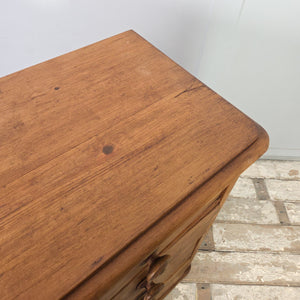 A Victorian farmhouse style chest of drawers made from rustic pine, offering five drawers with original knobs set above a plinth base. The wax-enhanced patina and simple lines give it a strong country house style character.
