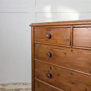 A rustic pine Victorian chest of drawers sealed in wax, with original knobs and a plinth style base. Its spacious five-drawer layout and country house style design offer dependable storage for a bedroom or hallway.