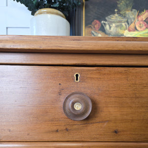 Victorian pine chest of drawers in a classic two-over-three layout, finished in wax to highlight the rustic patina. Original knobs and a plinth base give it a farmhouse style feel suitable for cottage style storage.