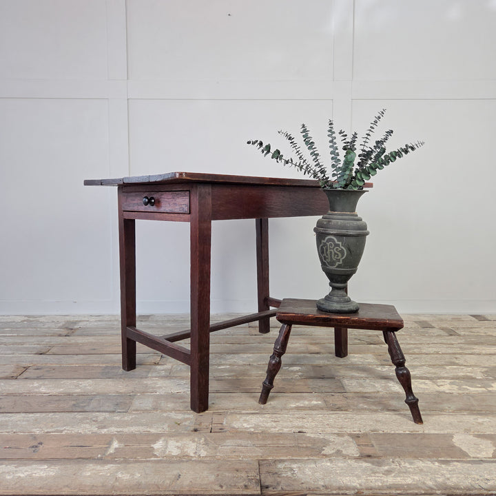 19th century Welsh oak farmhouse style table, compact in size, with four planked top, single drawer and slim legs on H-stretcher. Antique side table, hall table or kitchen table with rustic country charm and useful storage drawer.