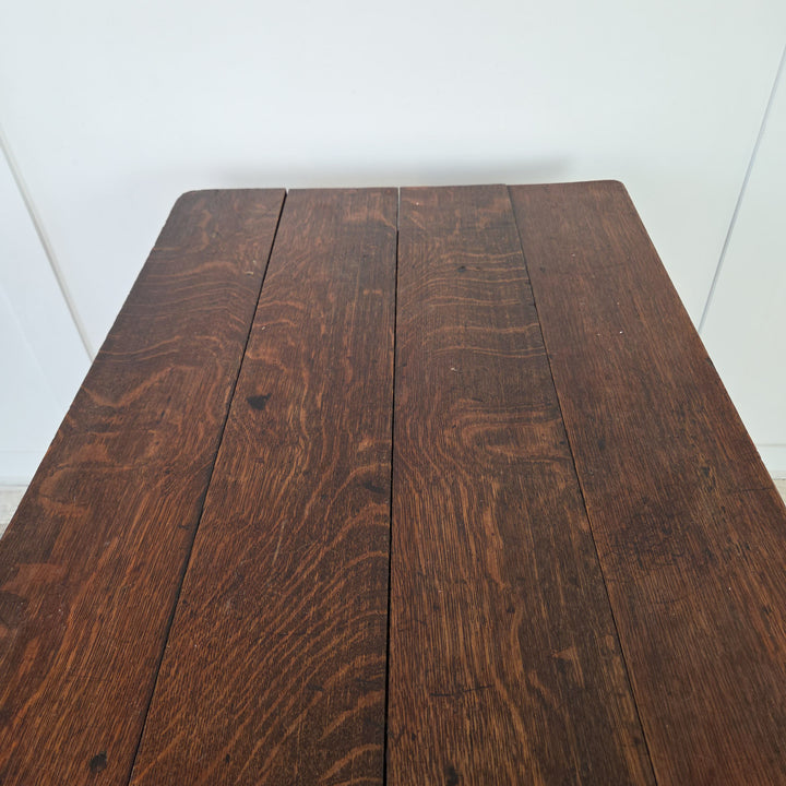 A farmhouse style antique table, 19th century Welsh oak dairy table with planked four-board top, practical drawer beneath, and slim stretchered legs. Compact in form, this oak hall table or side table brings rustic farmhouse charm.