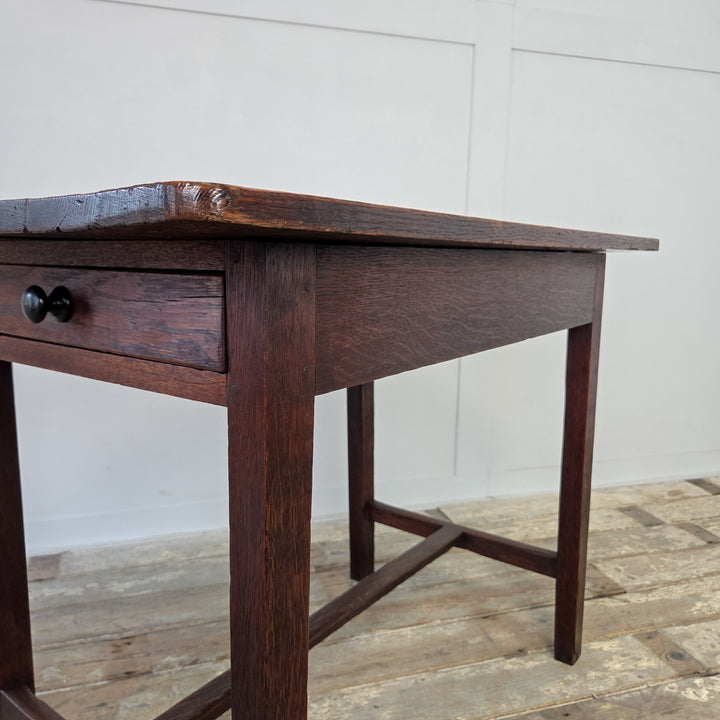 Compact Welsh oak farmhouse style dairy table, 19th century, with planked four-board top, drawer and stretchered legs. Antique oak table that serves as a hall table, side table or kitchen table within rustic farmhouse interiors.