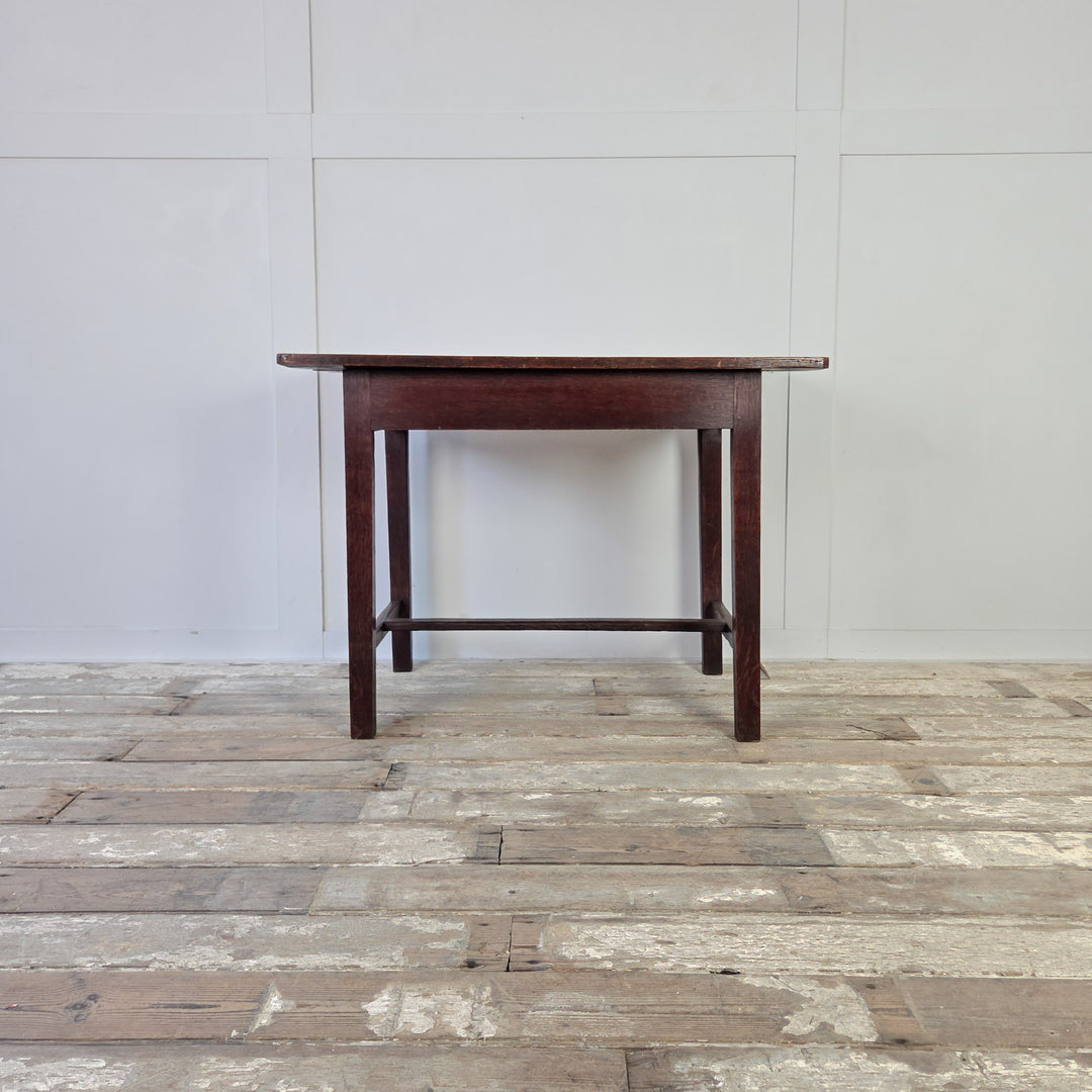 Antique farmhouse table in oak, 19th century Welsh dairy table with four planked top, long drawer, and slim legs with stretcher. Compact antique table that adapts well as a hall table, kitchen table or rustic oak side table.