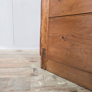 Antique workshop drawers from the early 20th century, made using mixed timbers and featuring two drawers and a small lower cupboard with a drop-down front. Finished in rustic pine wax, this industrial-style piece is well suited for use as a bedside table in the bedroom or an end table in the hallway or living room.
