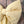 A handmade decorative Country House Bow created from vintage yellow patterned fabric. Individually crafted with a padded form and long tails, each bow is finished with an antiqued brass ring for hanging in interiors or at weddings.