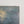 Early 20th century romantic oil painting of a coastal scene with a castle and dark stormy sky
