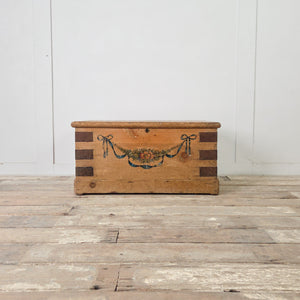 19th century French pine blanket box with original hand-painted floral decoration and iron banding to the corners
