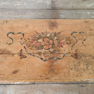 19th century French storage chest with folk art painted decoration, iron corner straps and carrying handles on each side
