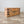 Antique French chest with hand-painted ribbon and bow garland, iron corner banding and hinged lid with paper lining
