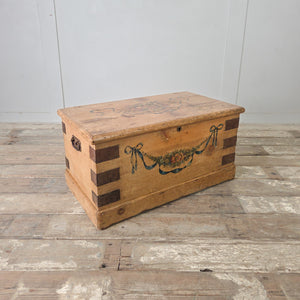 French antique pine trunk with original hand-painted floral garland suspended from blue ribbon bows at each corner
