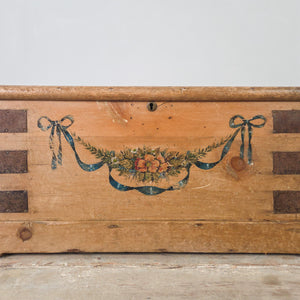 Antique painted pine chest with hand-painted ribbon and bow garland decoration and iron carrying handles on each side
