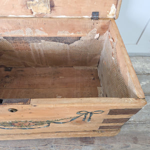 19th century painted pine trunk with original folk art decoration, iron corner banding and swing handles on each side
