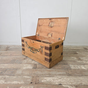 Antique French pine trunk with hand-painted floral and ribbon decoration to the front and remnants of original paper lining
