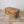 French folk art chest in pine with hand-painted garland of flowers tied with blue ribbon bows at each corner
