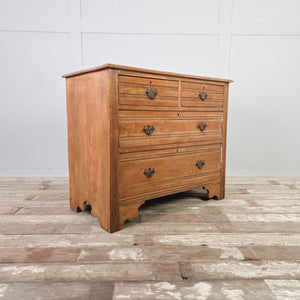 Antique ash dresser chest with four drawers, horizontal reeding and solid plinth base with bracket-style feet.
